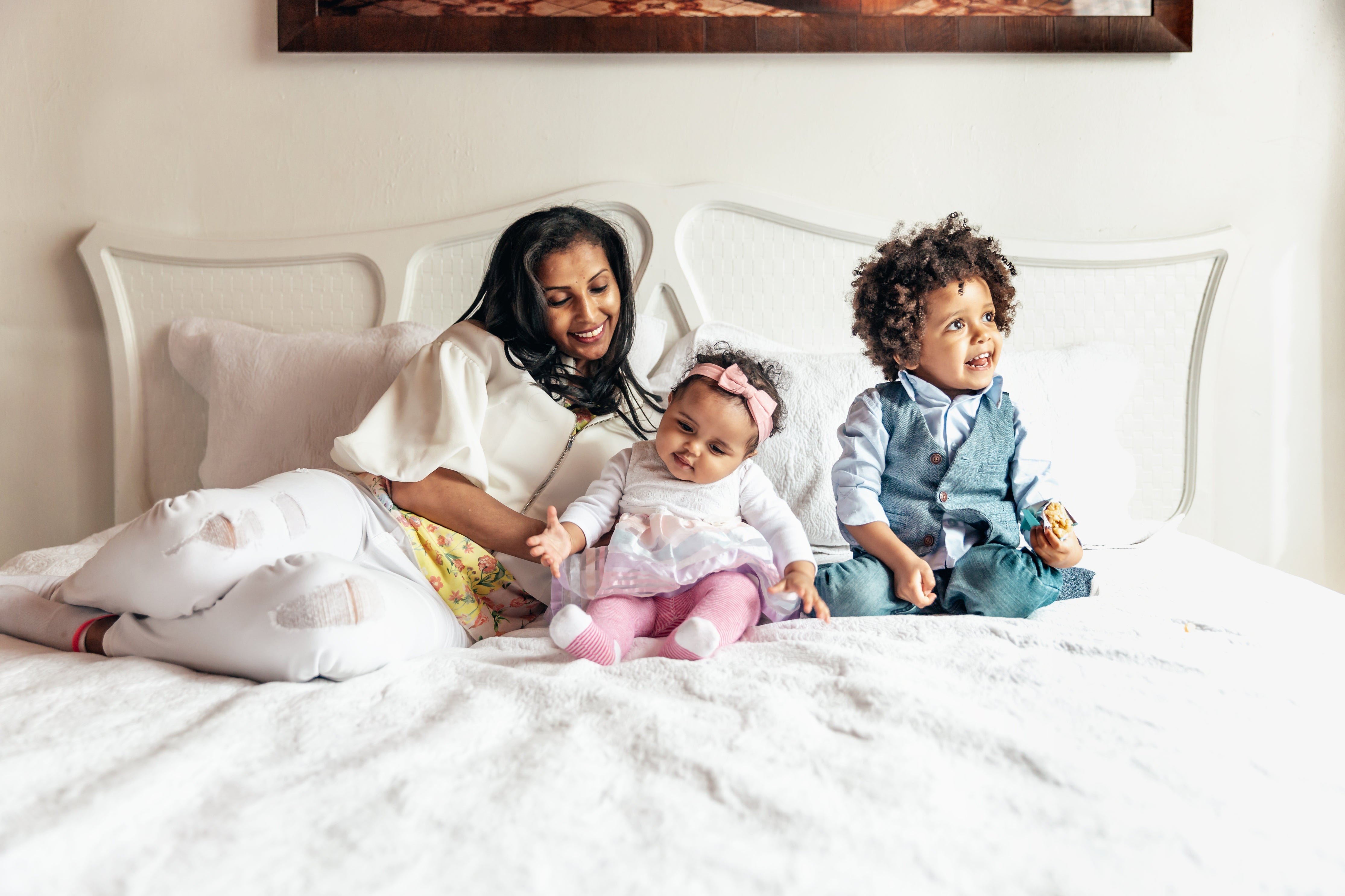 Lady and kids laying on sustainable, hypoallergic soft atluxe bedsheets