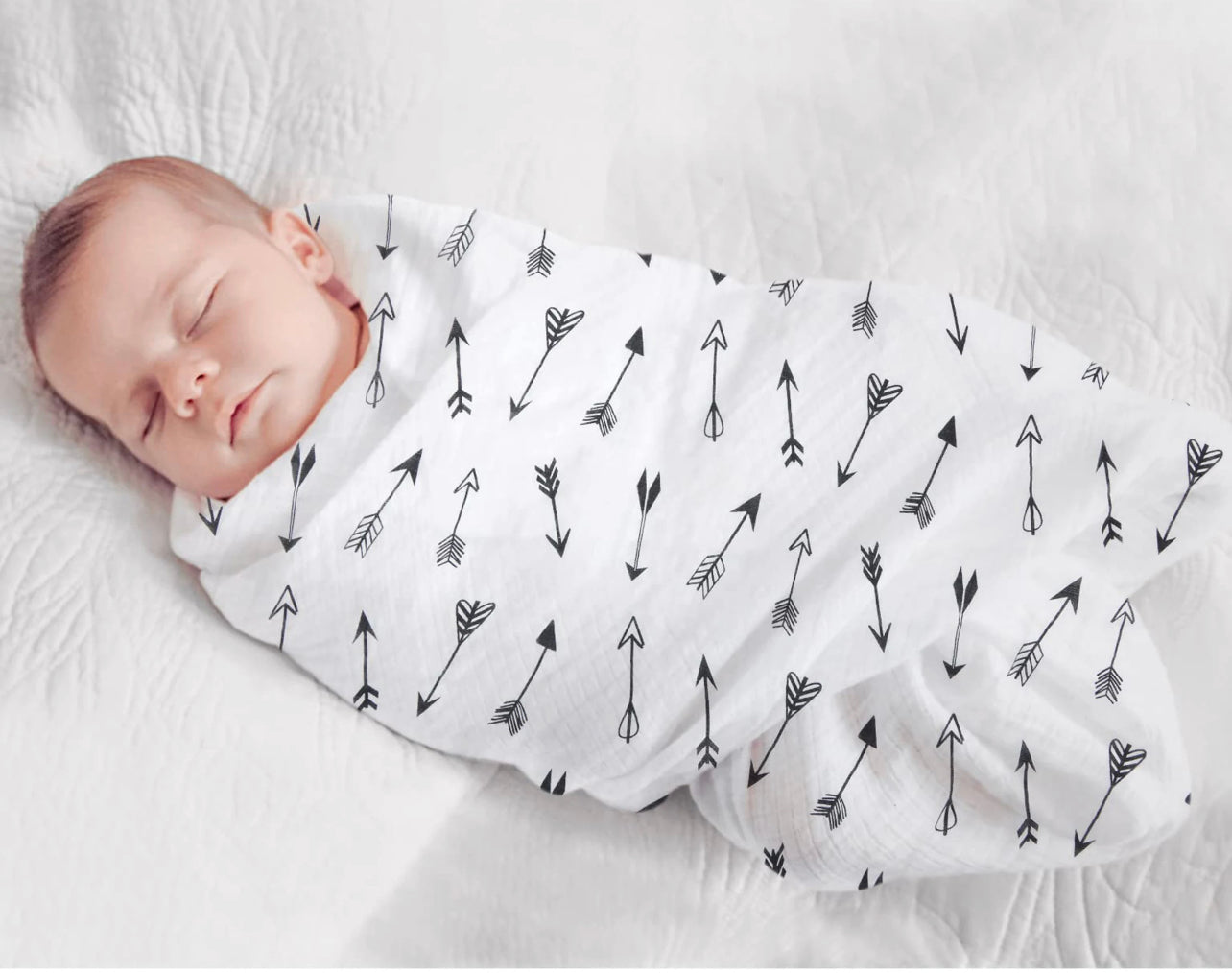 Baby sleeping comfortably in atluxe swaddle