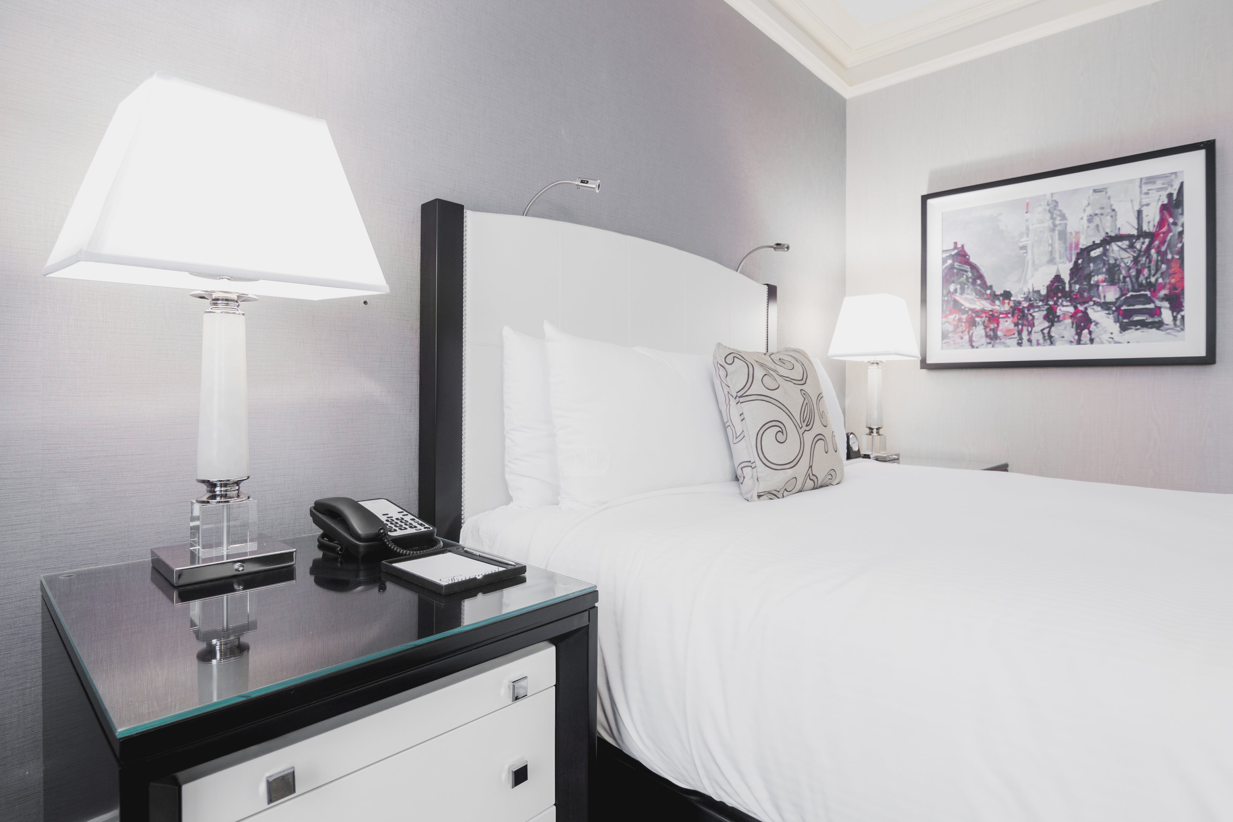 Hotel bed with white atluxe bedsheets and comforter proving comfort for Airbnb bed