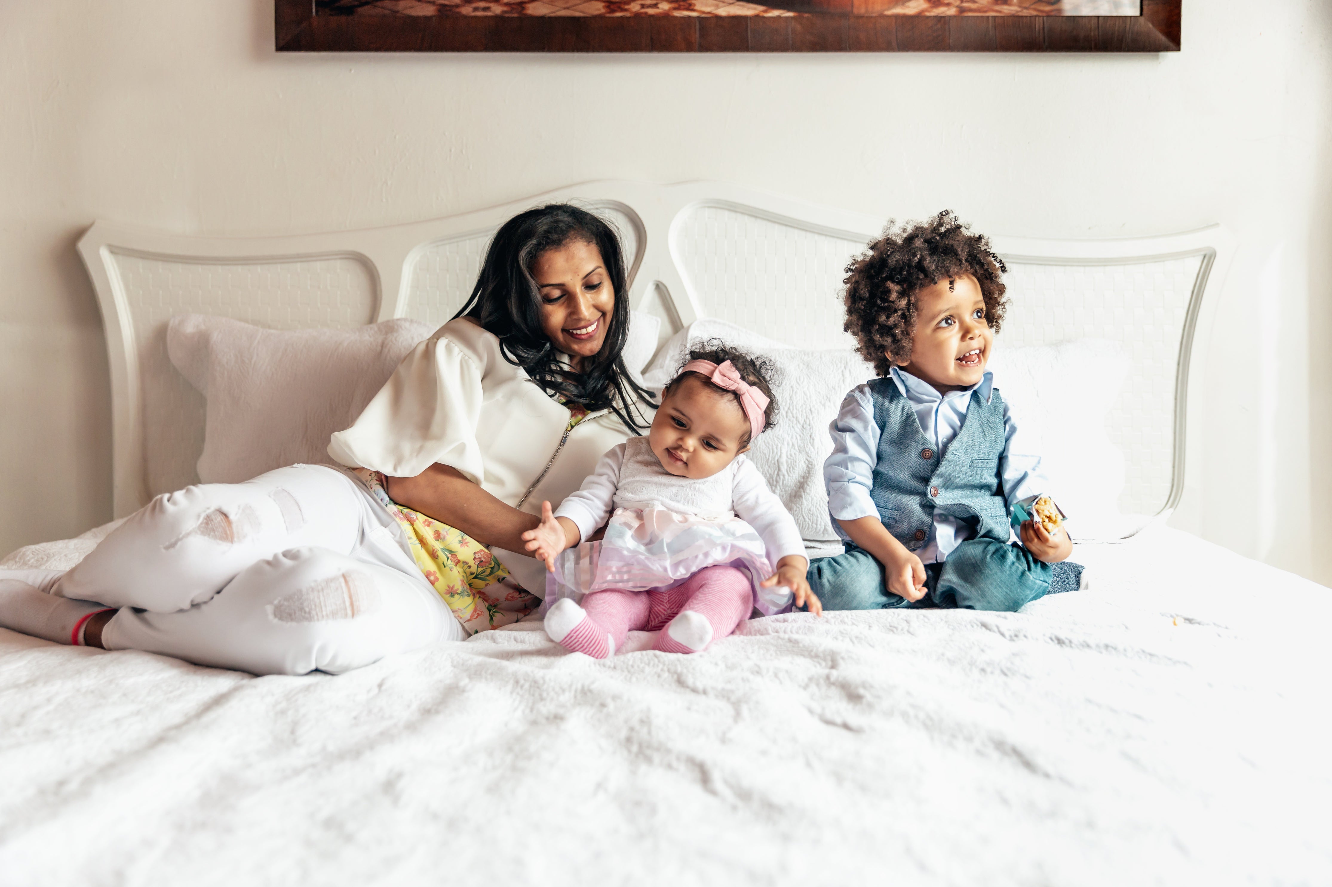 Lady and kids laying on sustainable, hypoallergic soft atluxe bedsheets 