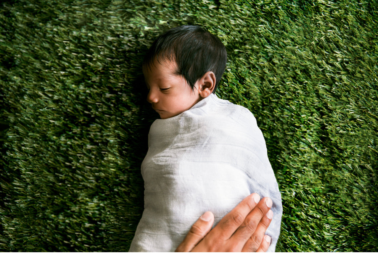 Baby wrapped in Atluxe sustainable luxurious bamboo cotton swaddle